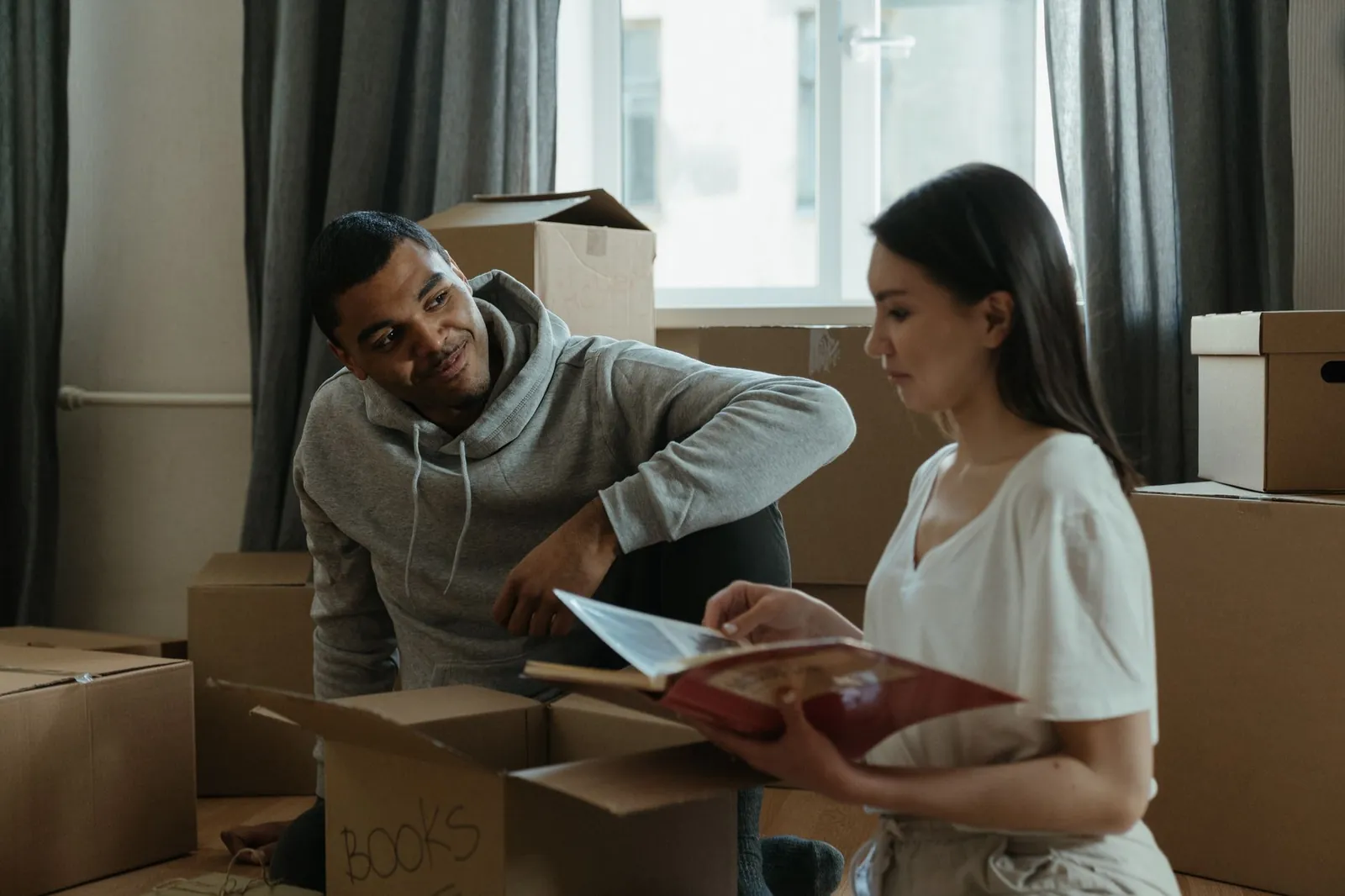 Unpacking cardboard moving boxes in a new apartment