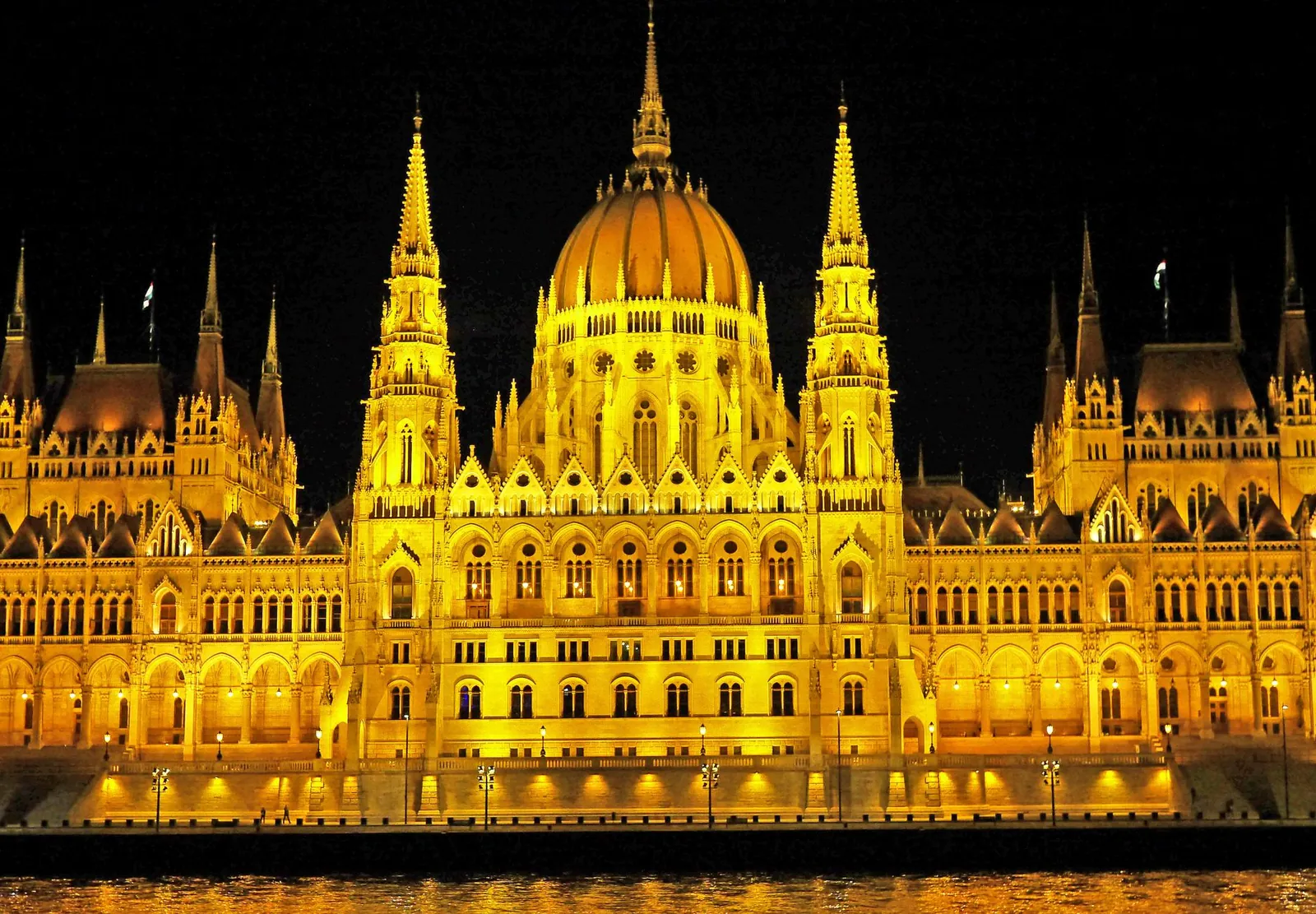 The Hungarian Parliament lit up at night beside the Danube in Budapest
