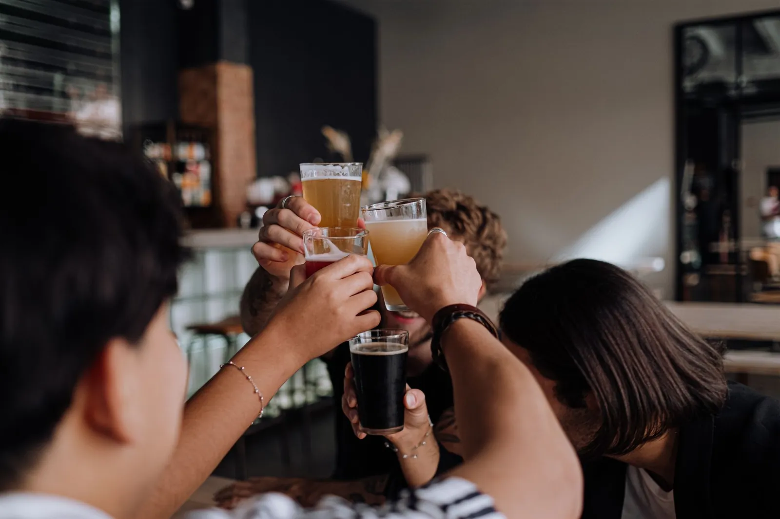 People talking and laughing together over drinks in a relaxed Budapest cafe